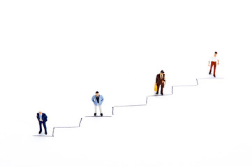 Miniature people on white with some diagrams