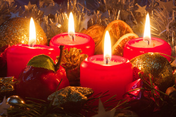 Four candles and christmas decorations.