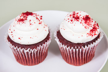 Two Red Velvet Cupcakes On A Plate