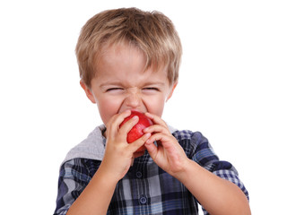 Boy biting a red apple