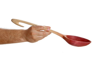 Male hand holding old wooden spoon