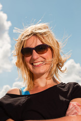 Happy pretty young blonde woman enjoying nature on summers day.