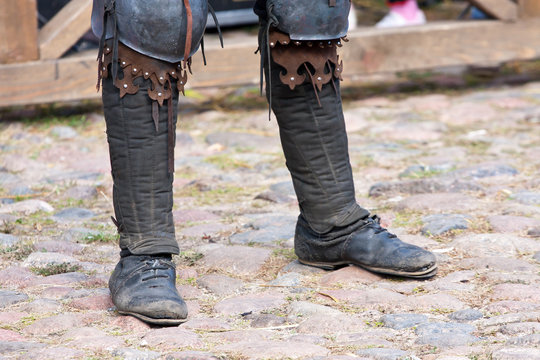 Legs of a man in the boots of a dark ages