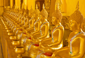 Fototapeta premium Row of golden buddha statue at Thailand Temple.