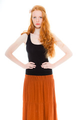 Pretty fashion girl with long red hair against white background.