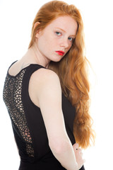 Fototapeta premium Pretty girl with long red hair and lipstick. Fashion studio shot