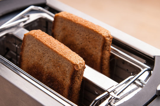 two hot bread toast in toaster