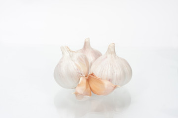 heads of garlic on a white