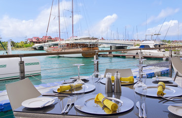 Table settings at restaurant on island's seaside with lagoon and