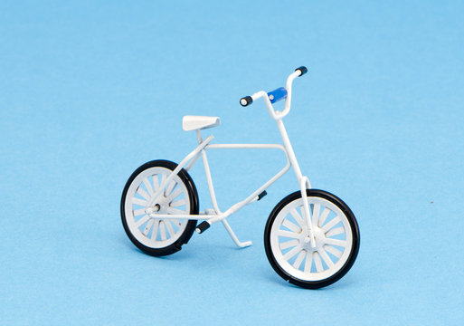 small bicycle toy on azure background