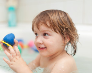   baby girl bathes  in bath