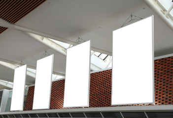 Blank billboard hanging from airport ceiling