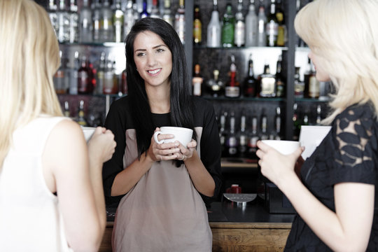 Women chatting over coffee at wine bar