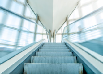 View of escalator in business centre in motion.