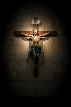 Crucifix in church on the stone wall.