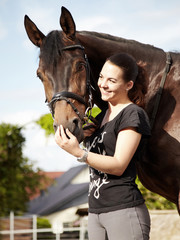 Dressage riding - woman proudly presents her horse outdoors