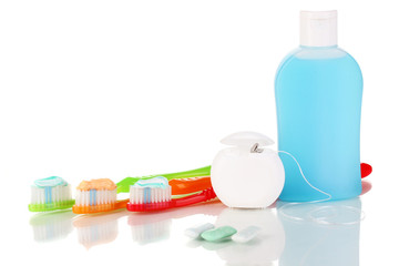 Toothbrush, chewing gum and dental floss isolated on white