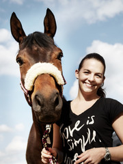 Dressage riding - woman proudly presents her horse outdoors