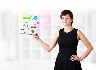 Young woman looking at modern tablet with colourful technology i