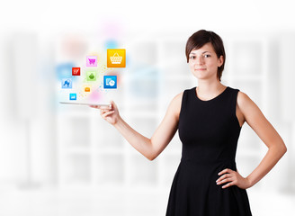 Young woman looking at modern tablet with colourful icons