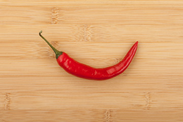 Chili pepper on wooden background