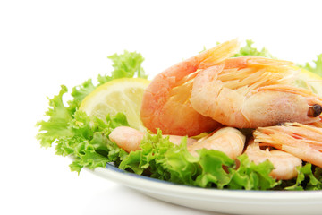 Boiled shrimps with lemon and lettuce leaves