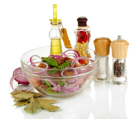 A large piece of pork marinated in bowl with herbs, spices and