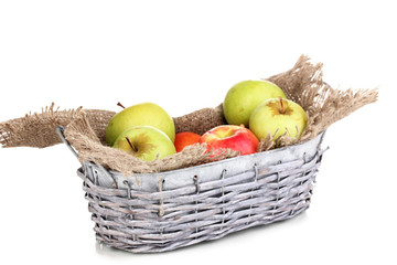 Ripe apples in basket isolated on white