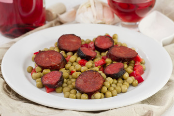 sausages with peas and red pepper on the plate
