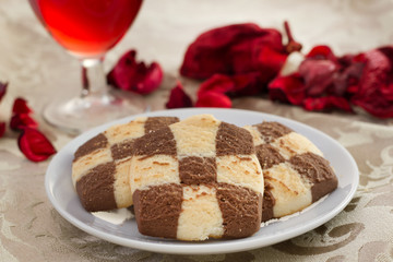 cookies on the plate and glass of wine
