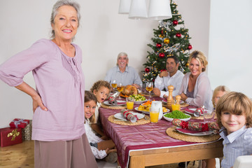 Grandmother standing beside dinner table