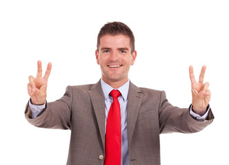 business man showing victory gesture