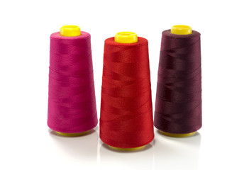 red pink and purple bobbin with thread