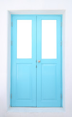 Light blue wooden door with cement wall.