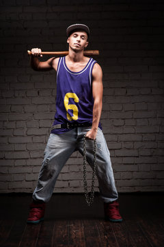 hip-hop style man holding baseball bat and chain