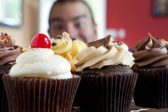 Man Looking At Cupcakes