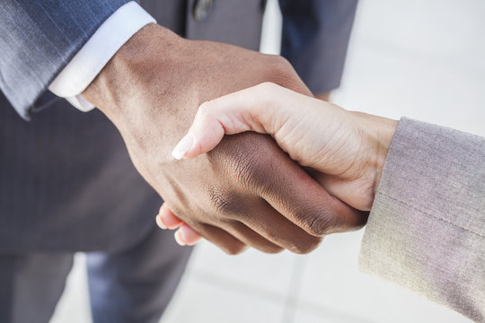 African American Businessman & Woman Shaking Hands