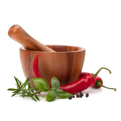 fresh flavoring herbs and spices in wooden mortar