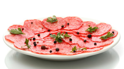 tasty sausage with spices on plate, isolated on white