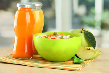 tasty dieting food and bottles of juice, on wooden table