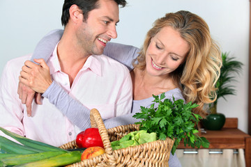 Wife puts arms around husband.