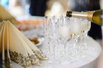 Pouring champagne into a glasses