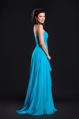 Fashion young woman in funky blue long dress smiling