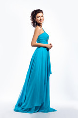 Obraz na płótnie Canvas Feminine. Gorgeous graceful smiling brunette girl in blue dress