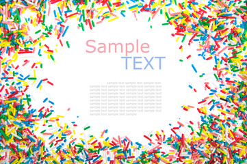 Frame made of little colorful sprinkles candy isolated on white