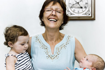 Grandmother with her grandchildren in her arms