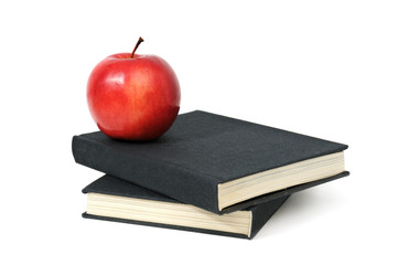 red apple on a book isolated on white background