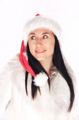 Brunette woman isolated in winter christmas fur and santa hat