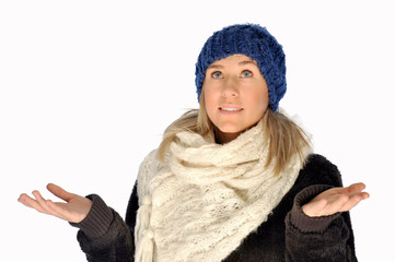 Blonde woman in winter clothes isolated with her hands spread