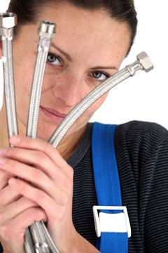 Female plumber with metal flexi pipes